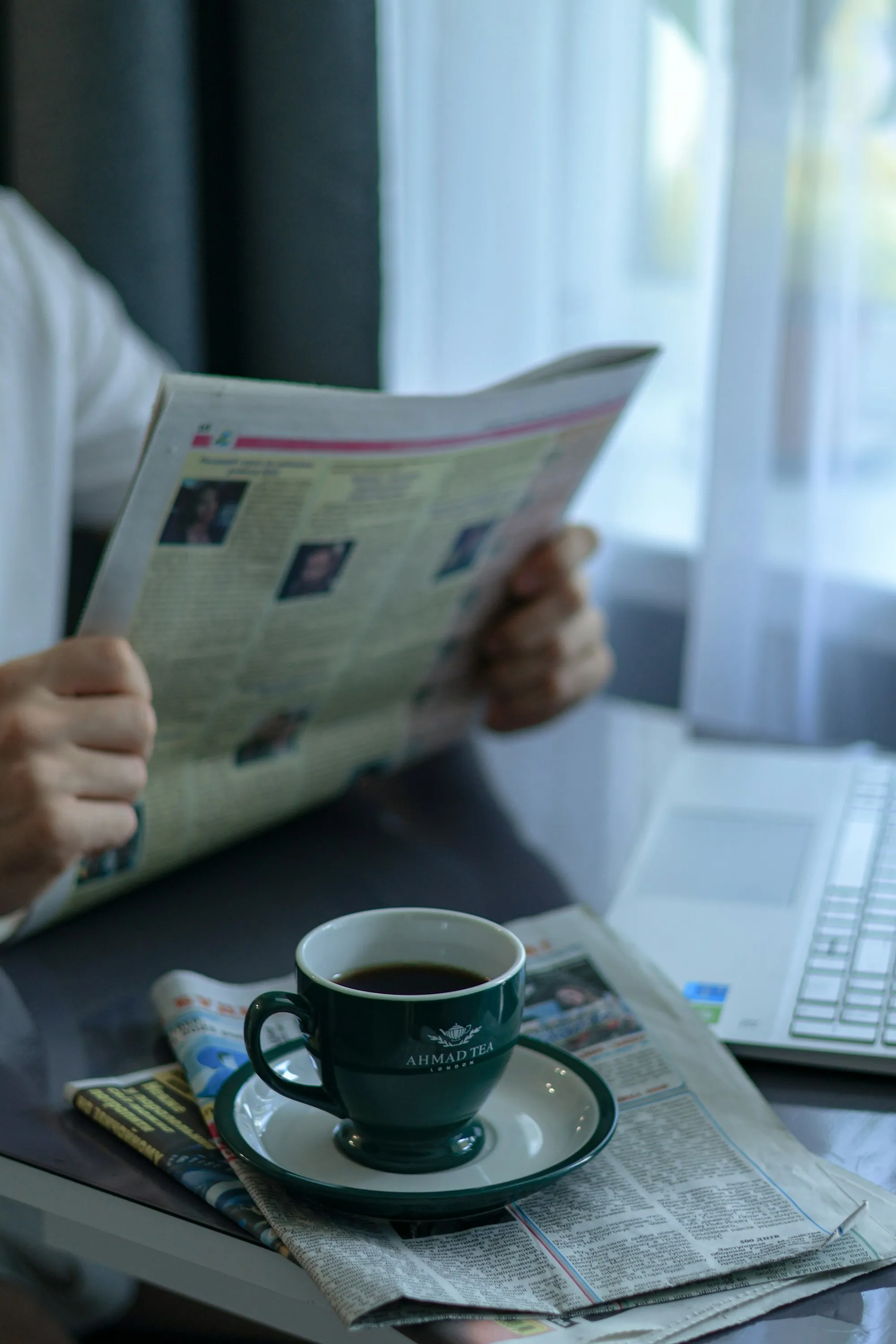 A reader with the weekly market update and a coffee