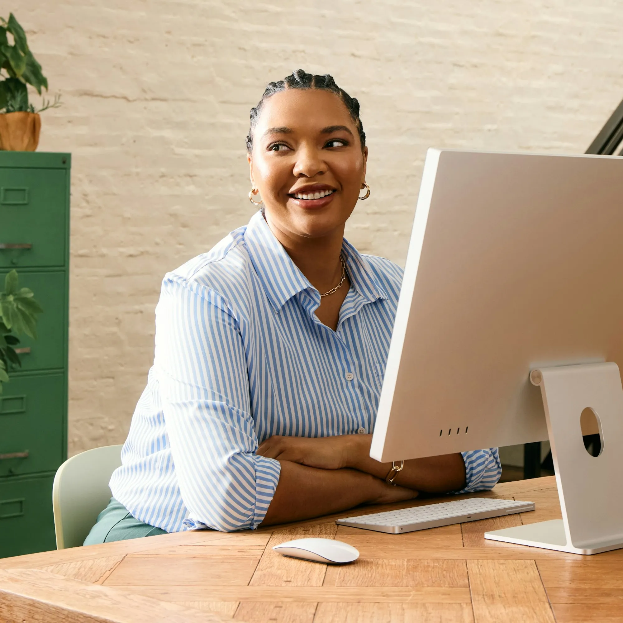 Young woman working out what she can afford on her laptop