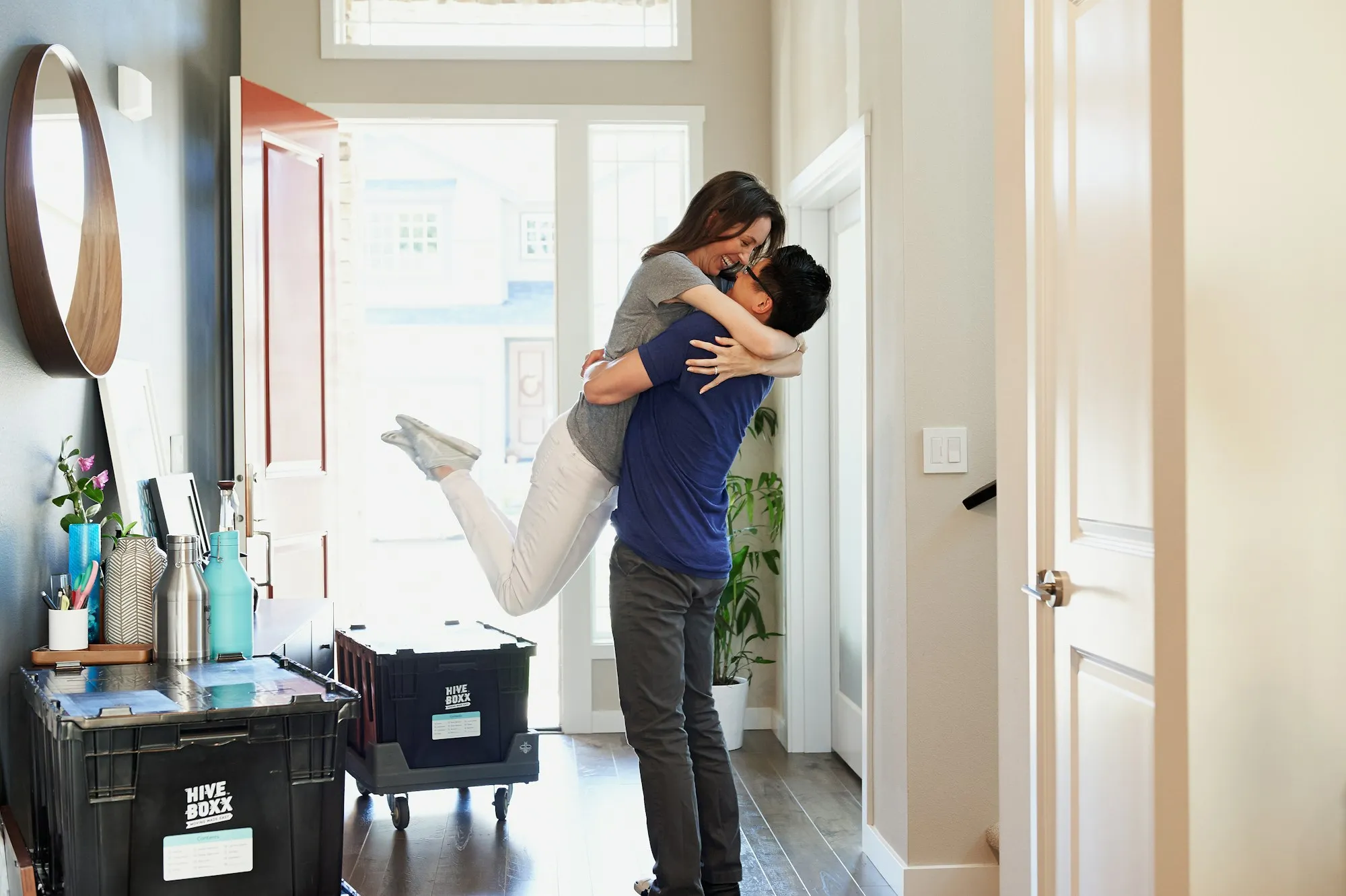 Happy couple holding the keys outside their new home