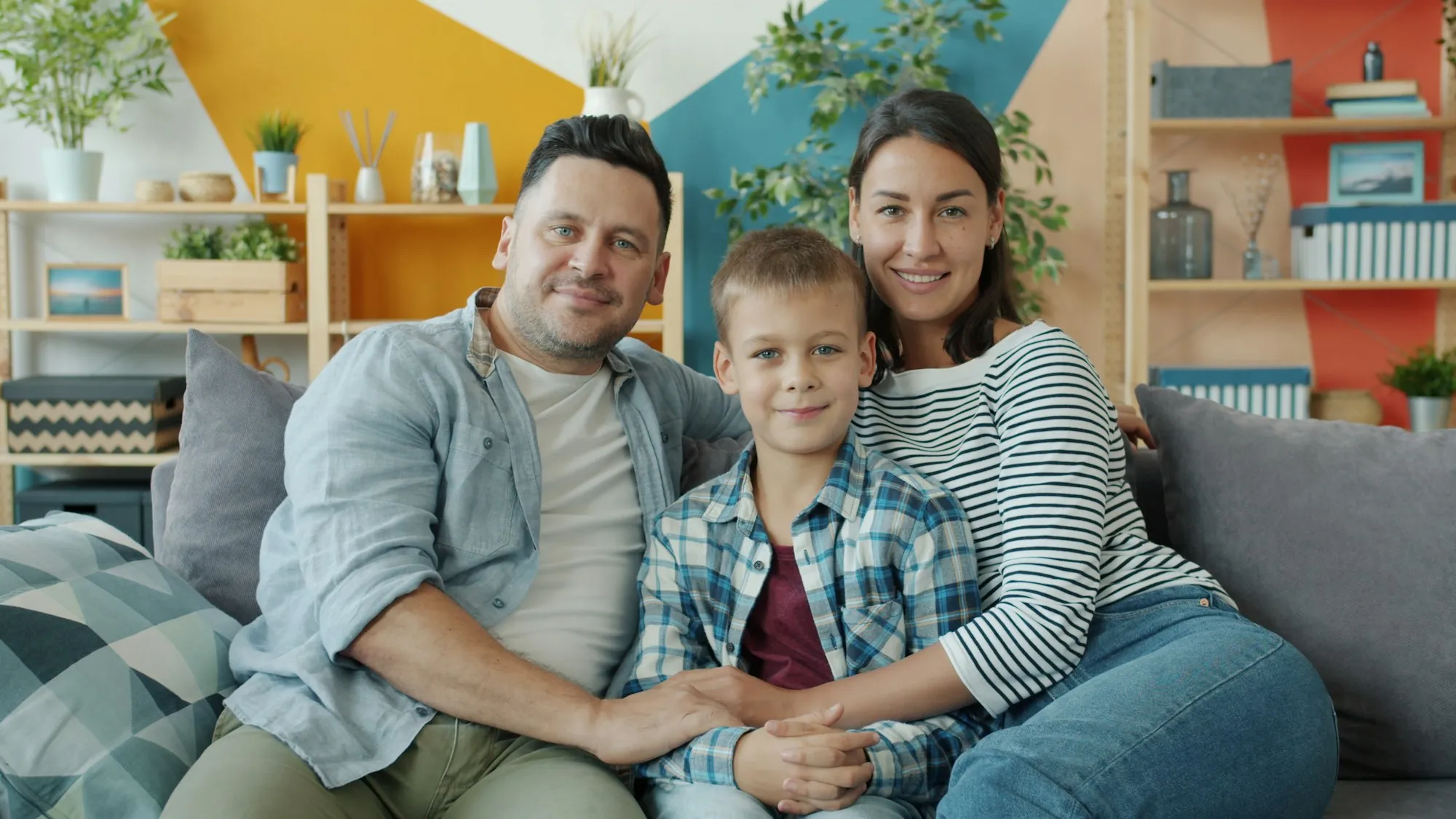 Family carrying moving boxes into their new home