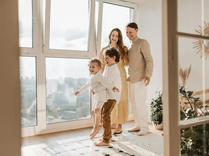 A family walking through a bright, sunlit home